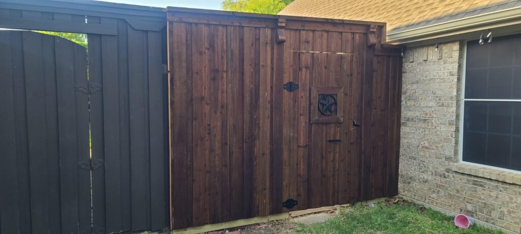 Dark-stained cedar double drive gate with Texas star and decorative corbels